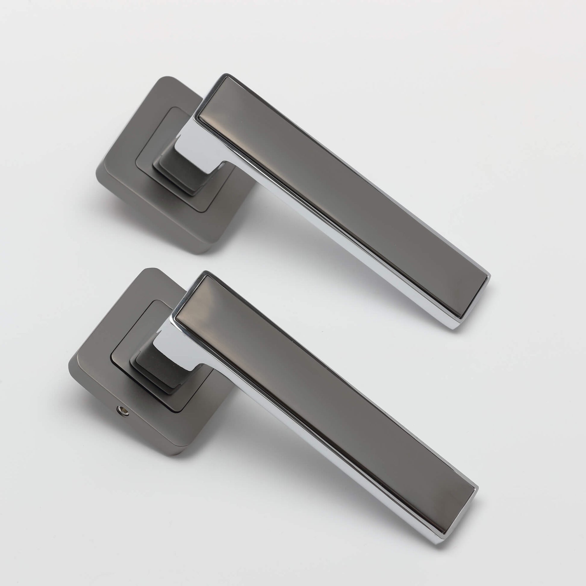 A set of Alto Matt Satin Black & Polished Chrome Square Rose Handles on a white background.