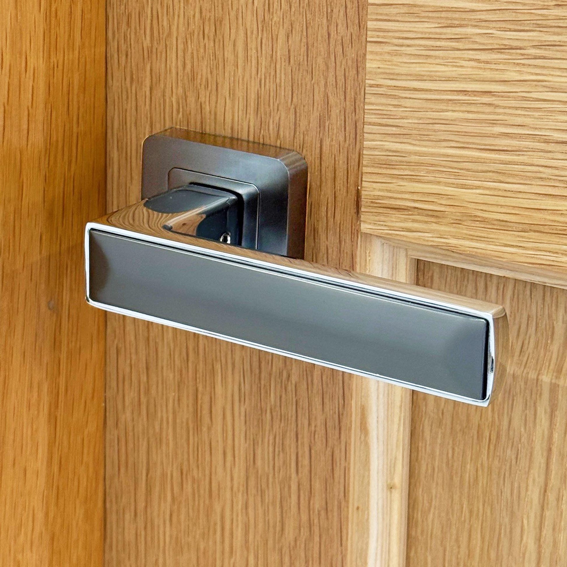 Alto Matt Satin Black and Chrome door handle on a oak wooden door