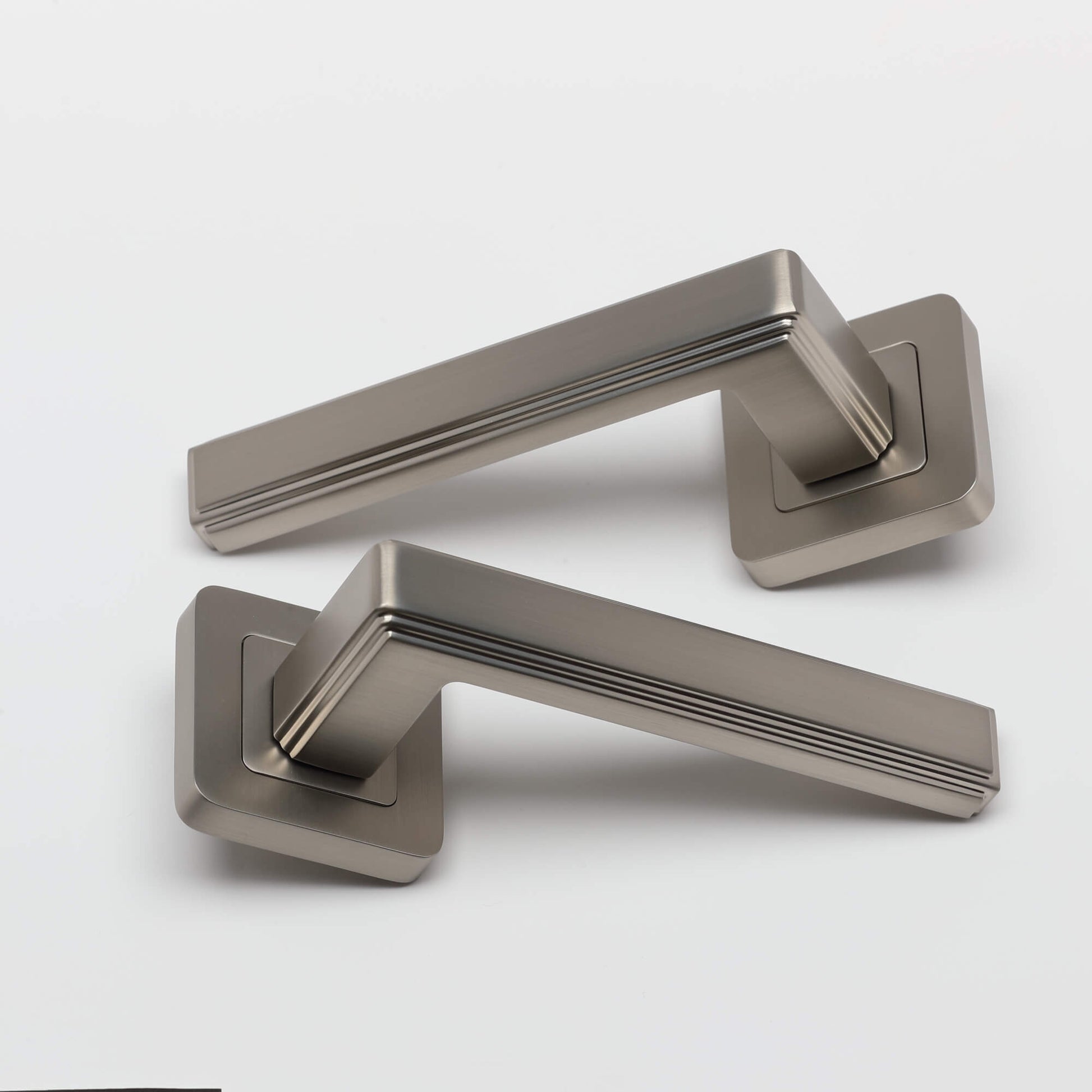 A pair of Ares Matt Satin Nickel Square Rose door handles on a white background.
