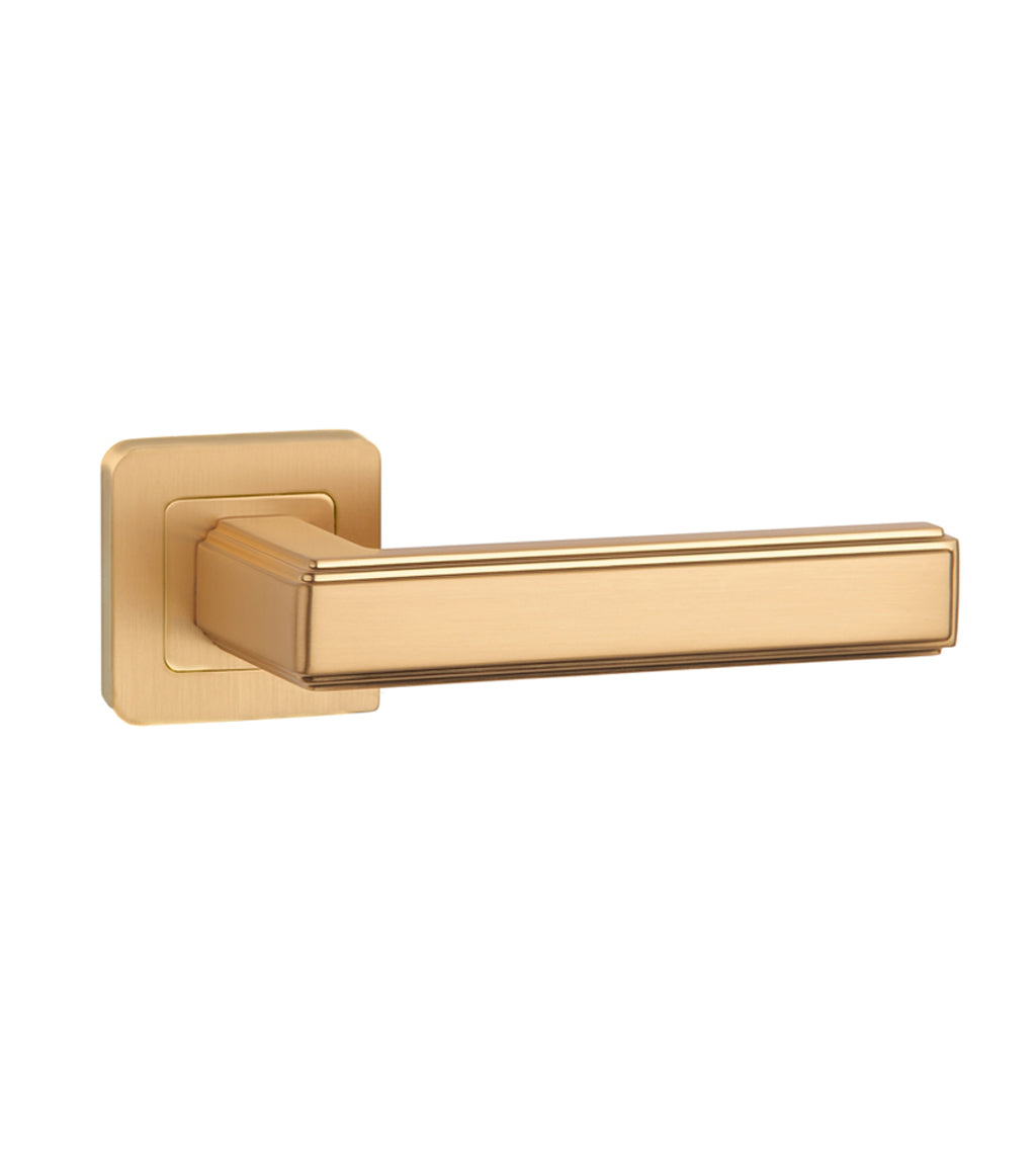 An Ares Satin Brass Square Rose door handle on a white background