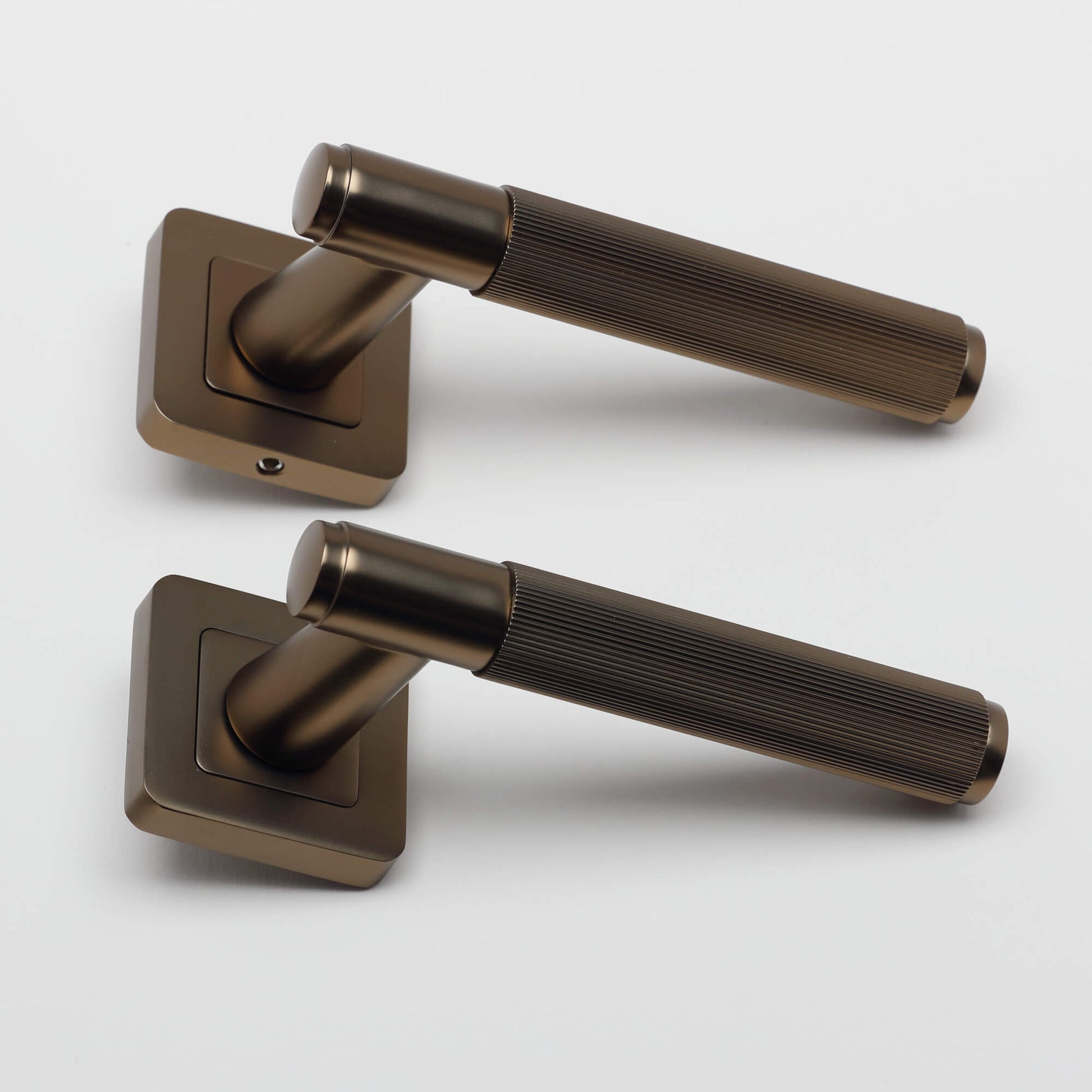 A side view of a pair of Athena Hermes Matt Coffee Square Rose Handles on a white background.
