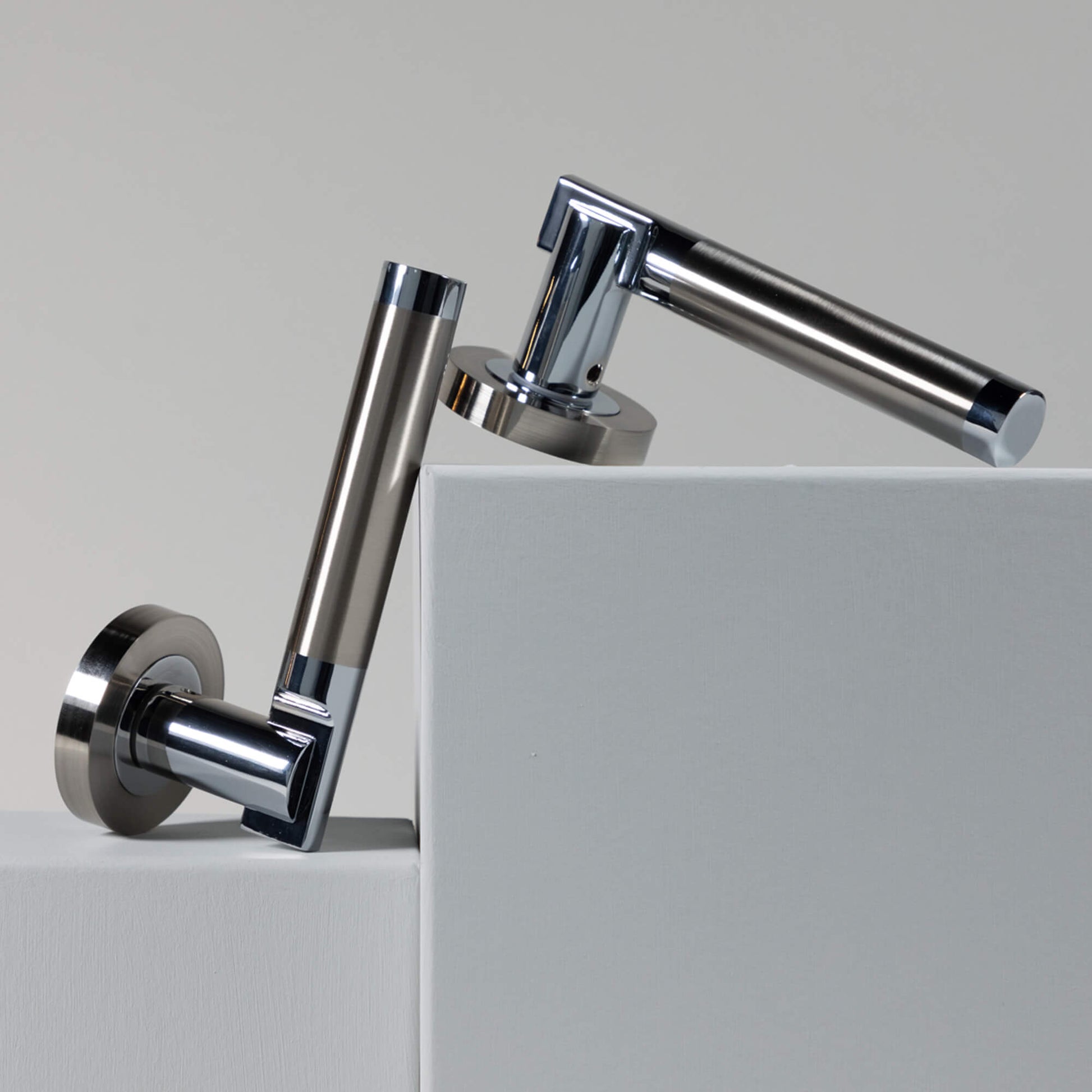 Cumulus Nickel Brushed & Polished Chrome Handles on a white surface with a grey background