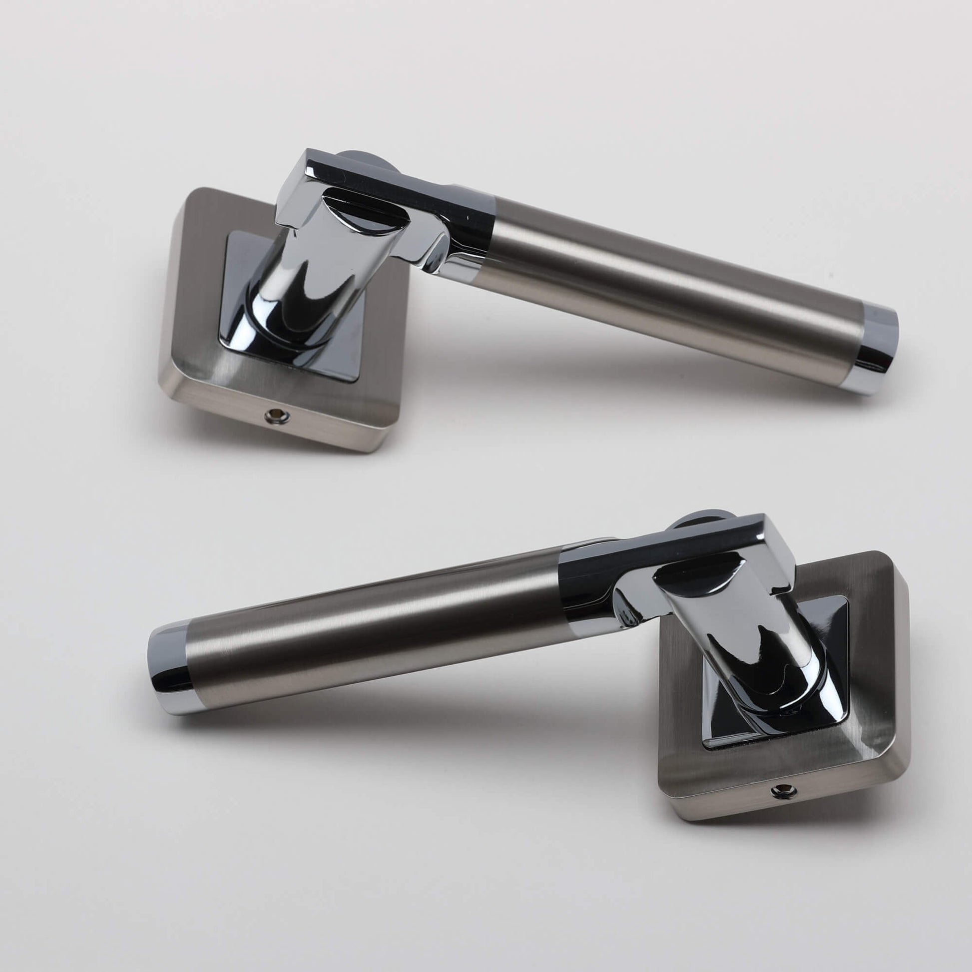 A pair of Cumulus Nickel Brushed & Polished Chrome Square Rose Handles on a light grey background.