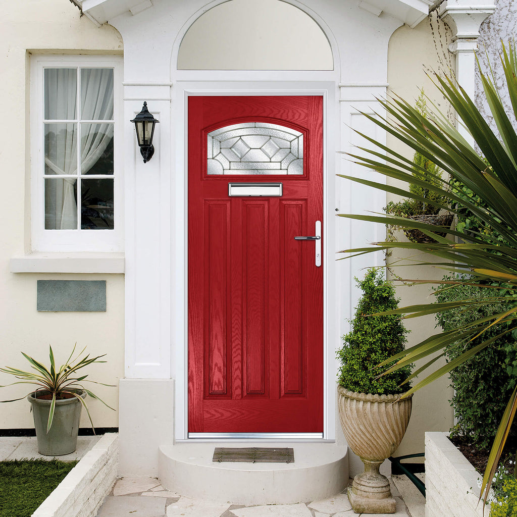 A red Edwardian Composite GRP Door with decorative glazed glass in a home front exterior