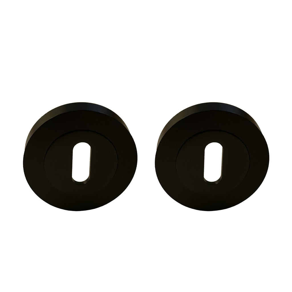 A pair o on a white background Flat Black Round Escutcheons on a white background