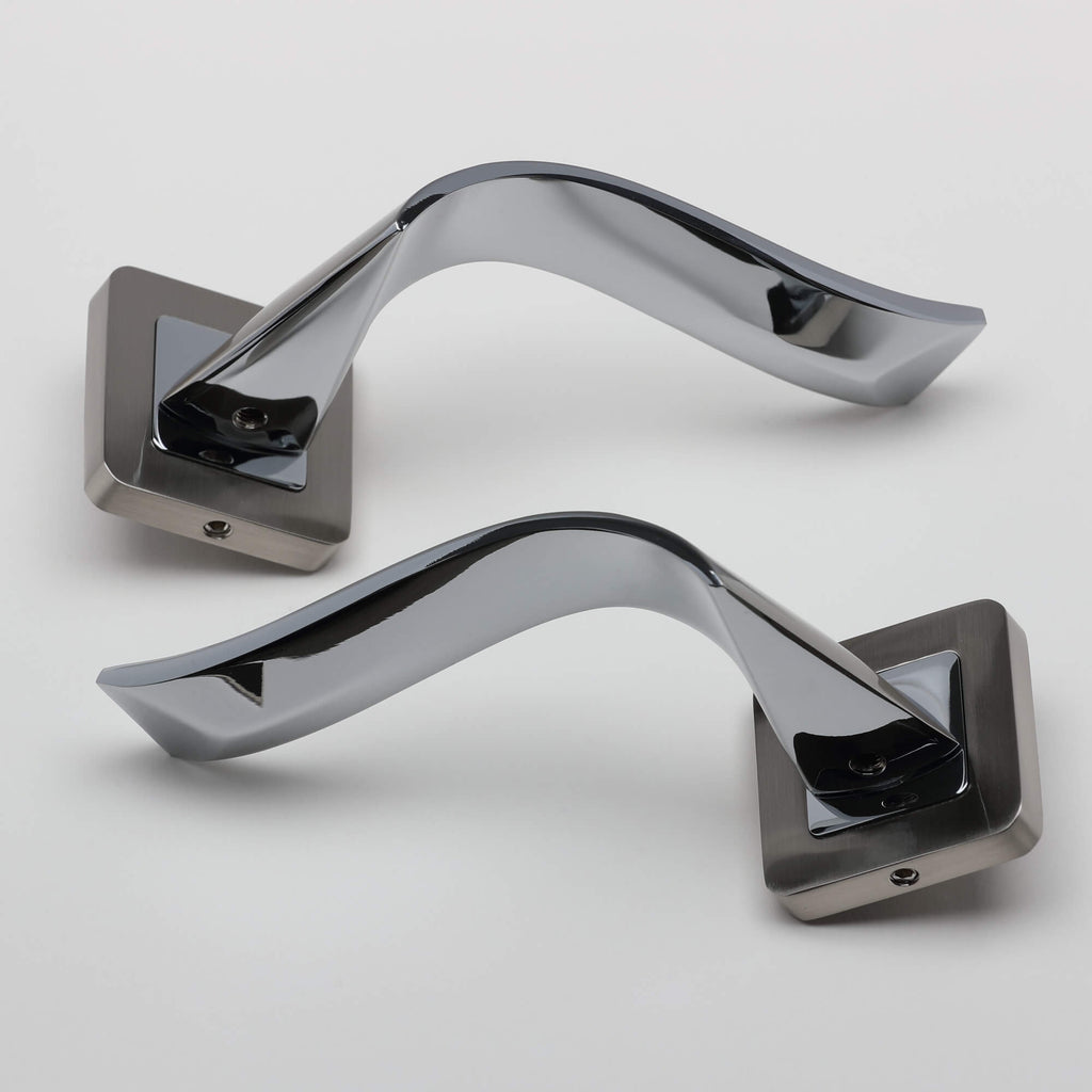 A pair of Incus Nickel Brushed & Polished Chrome Square Rose door handles on a light grey background.
