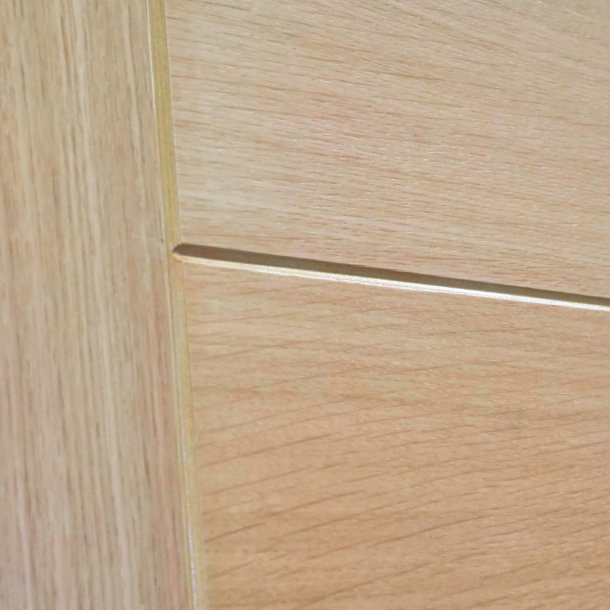 Close-up of a wood grain and v-groove on an Iseo White Oak 35mm Internal Door