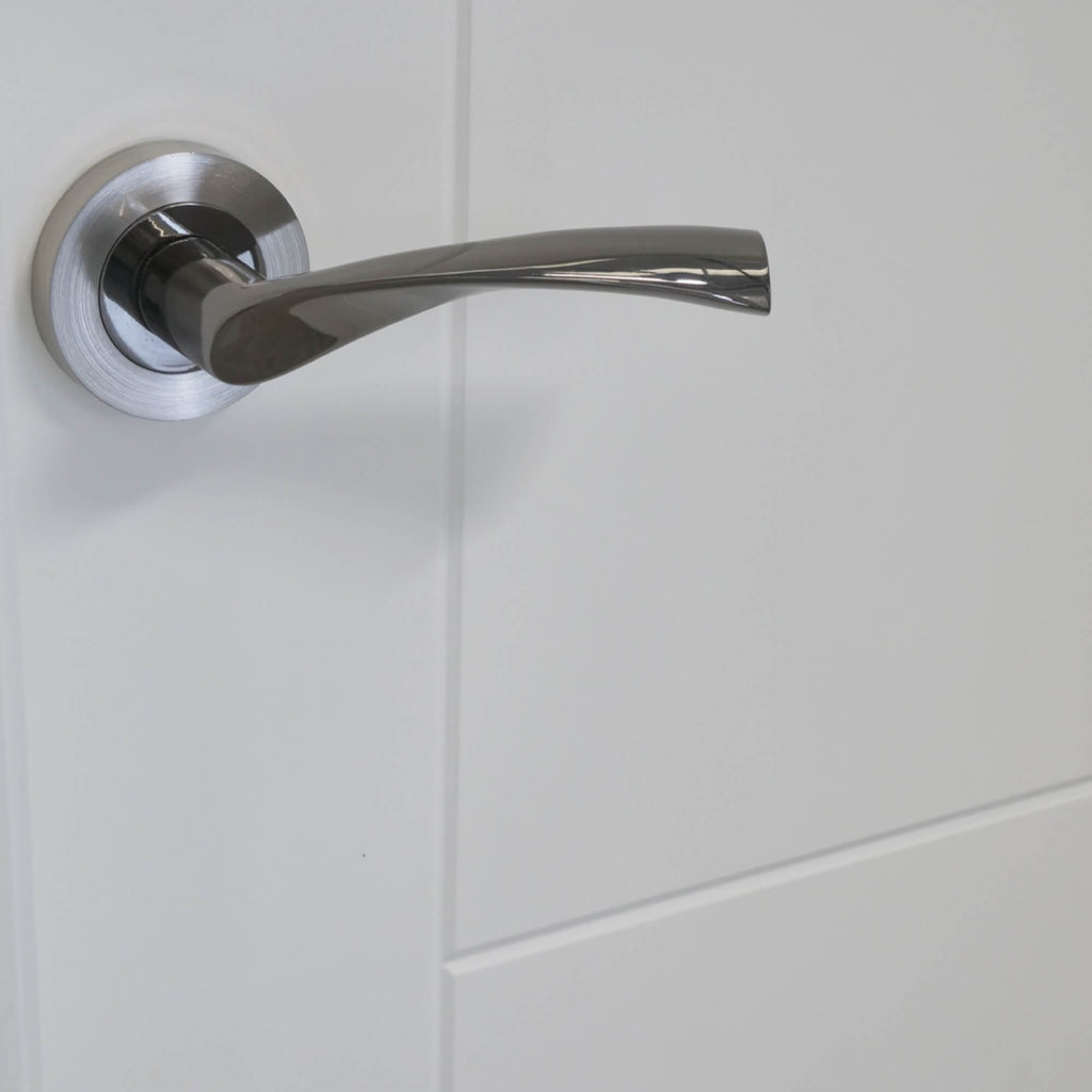 Close up of the grooves on an Iseo White Primed Door with a Trade Range Nickel Brass & Polished Chrome Handle.