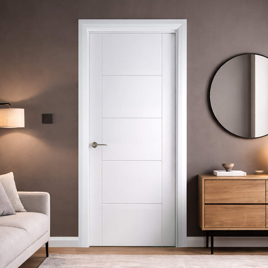 An Iseo White Primed Internal Door in a room with a grey wall, wooden cabinet, and grey sofa.