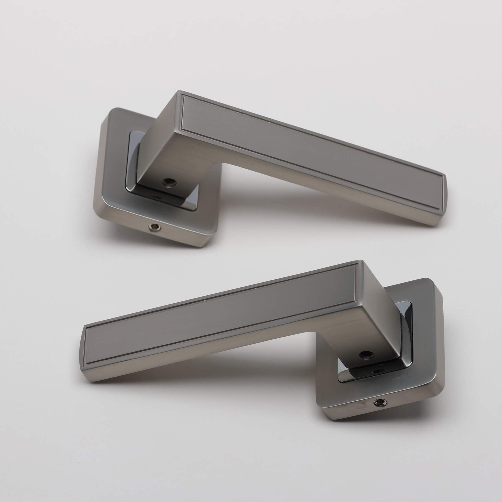 A pair of Jupiter Matt Satin Nickel & Polished Chrome Square Rose handles on a light grey background.