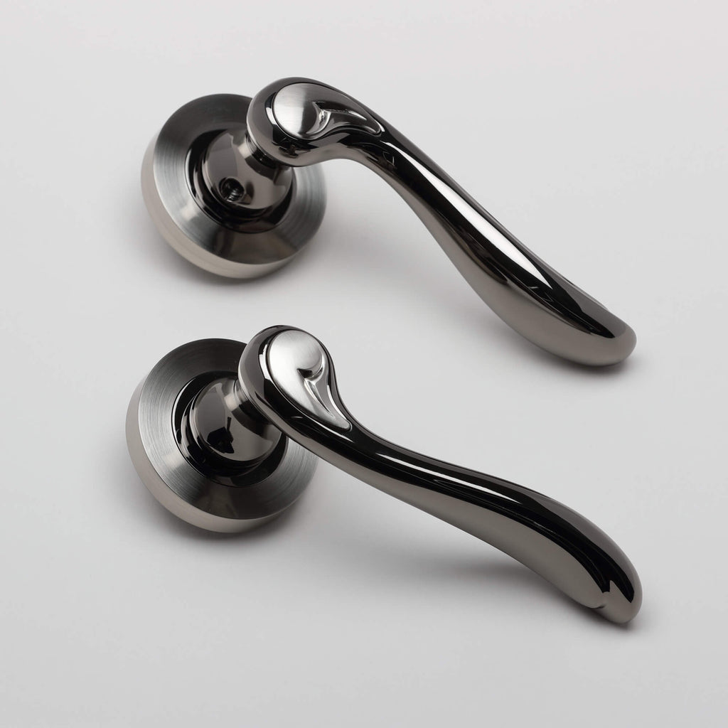 A pair of Monet Black Nickel & Nickel Brushed Round Rose Door Handle on a white background.