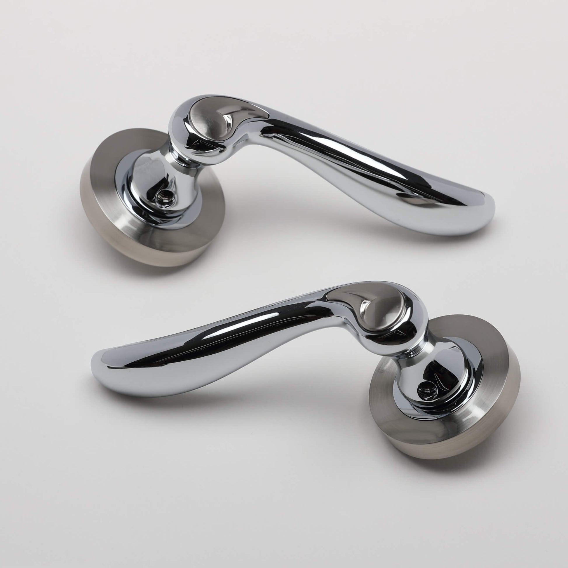 A pair of Monet Nickel Brushed & Polished Chrome Handle on a white background.