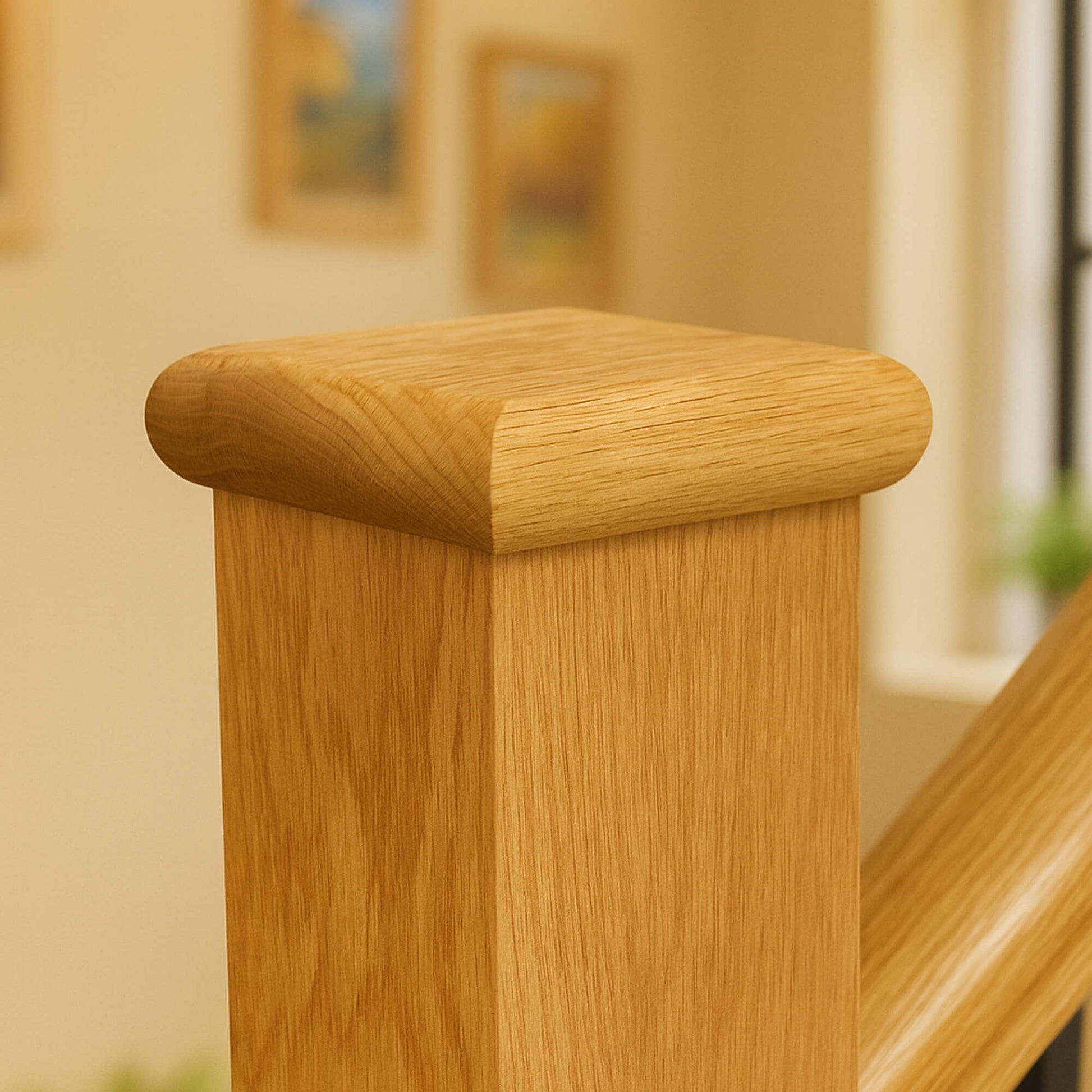 Close-up of an Oak Flat Newel Cap with a blurred indoor background