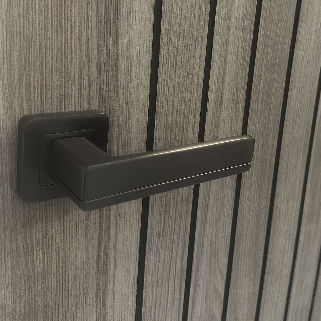Close-up of the panelling and woodgrain on an Ottawa Lava Grey 35mm Internal Laminate Door with a Flat Black Hermes handle.