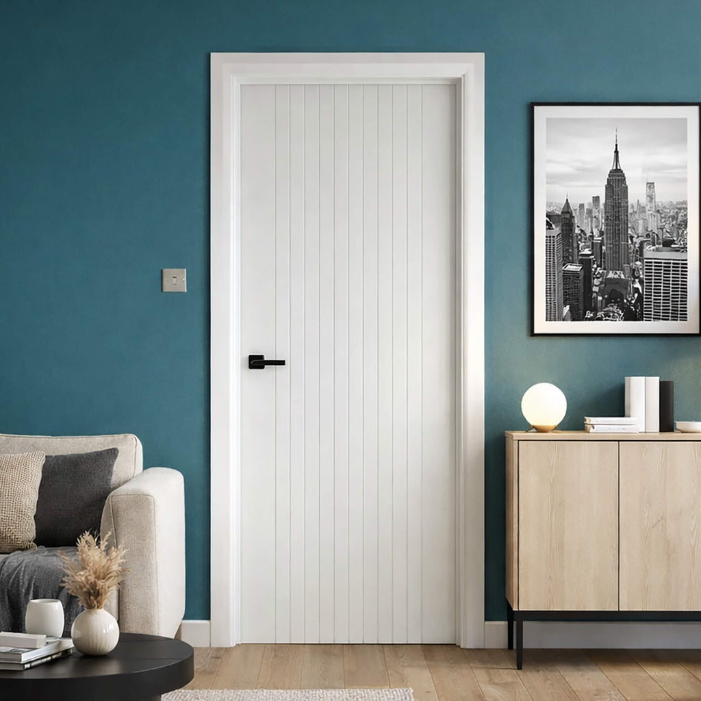 An Ottawa White Primed Door in a home modern interior setting with a blue wall, and wooden sideboard.