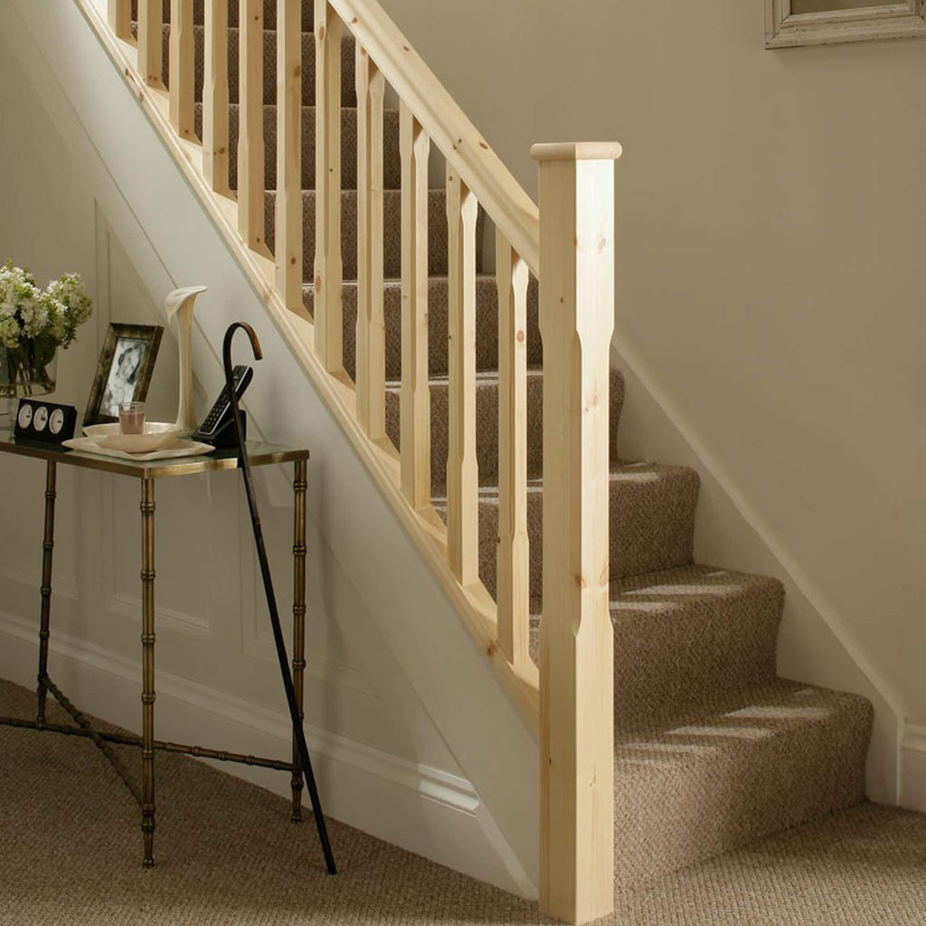 Redwood Pine Chamfered Spindles on a staircase with accompanying baseball and handrail.