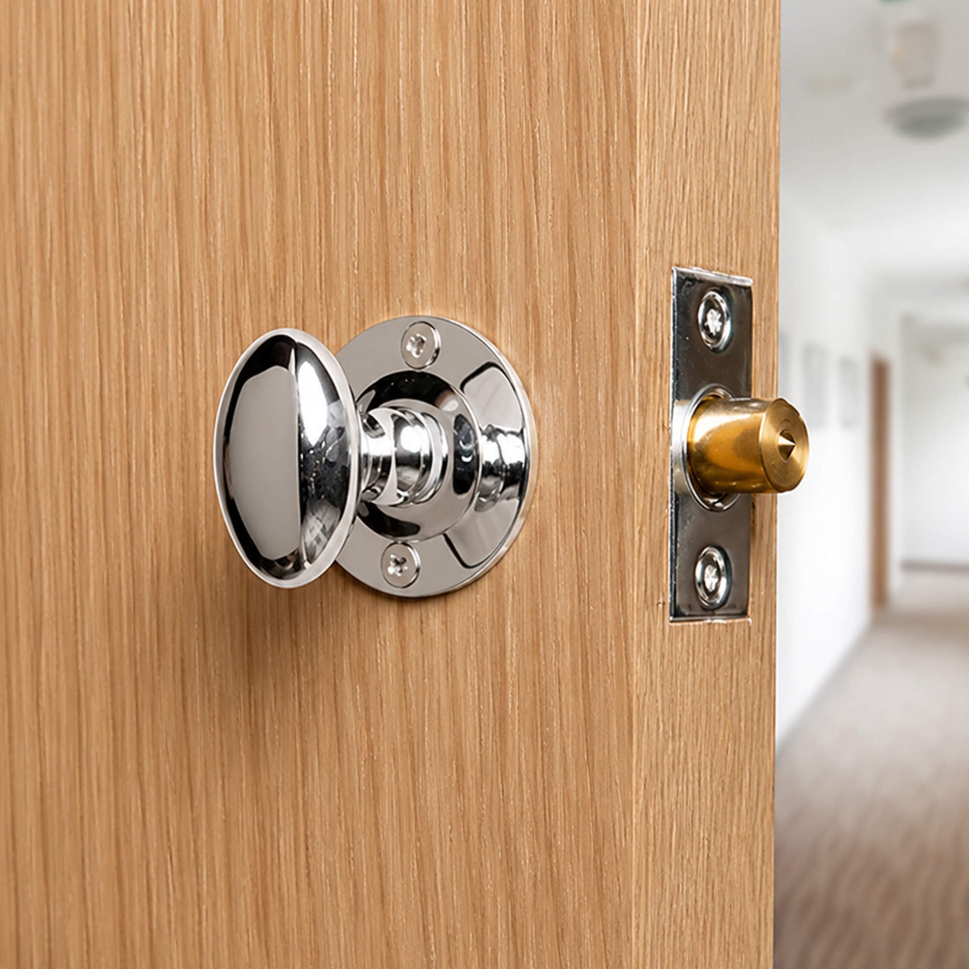 Close-up of a Polished Chrome Rack Bolt looking out into a hallway.