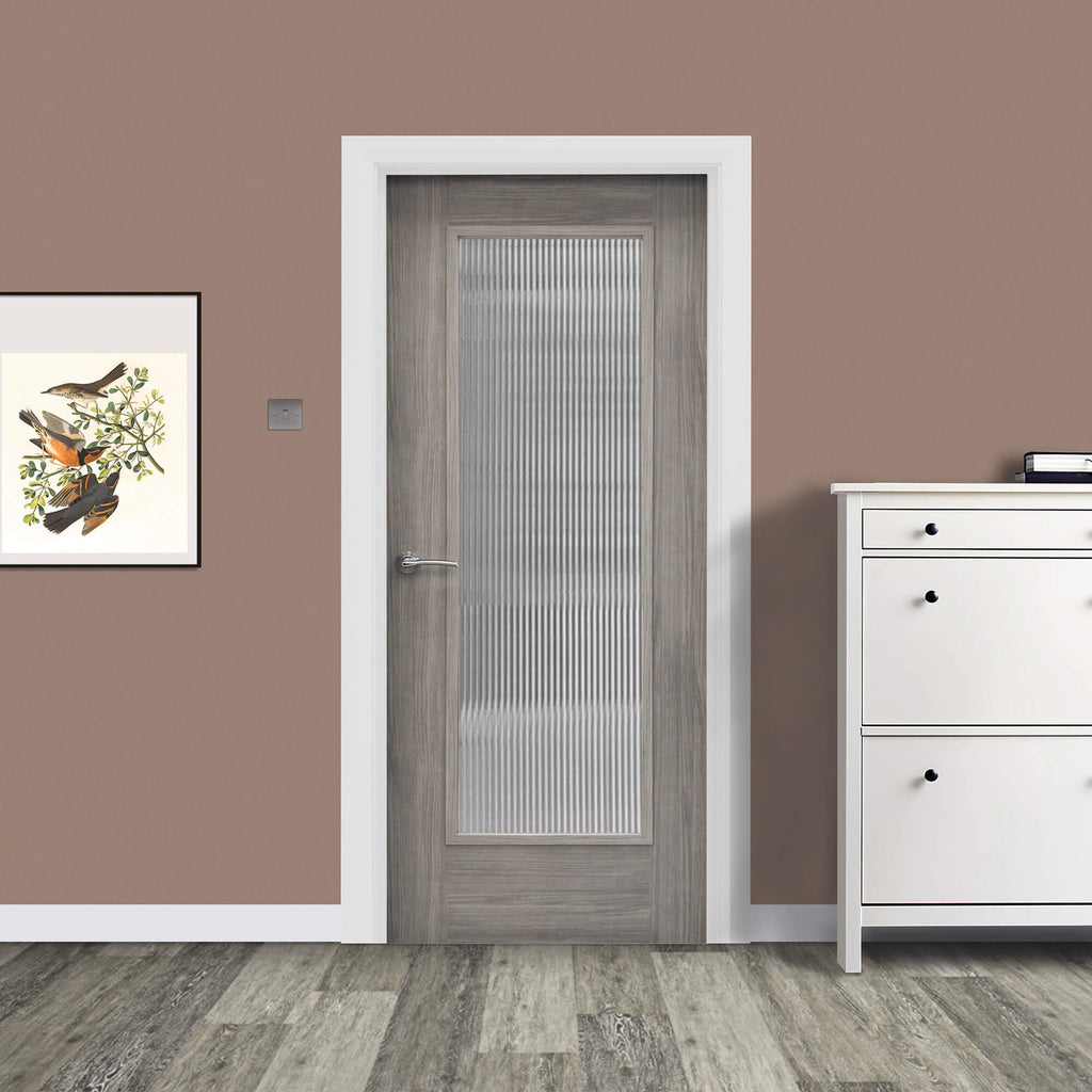 A Shaker Lava Grey 1 Lite Unglazed 40mm Internal Laminate Door, with 4mm reeded glass inserted and a Storm door handle, in a home interior setting.