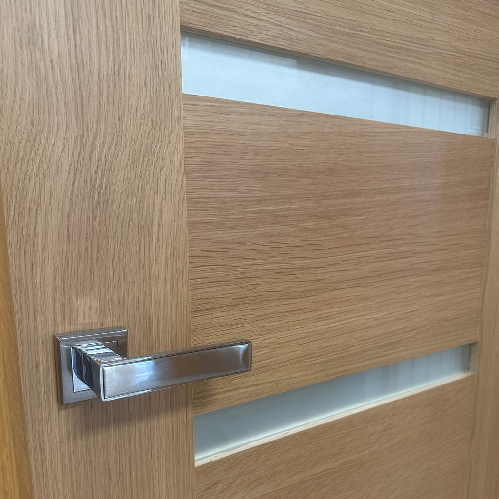 Close-up of a Shaker White Oak Vision Panel 40mm Internal Door with a Jupiter Handle.