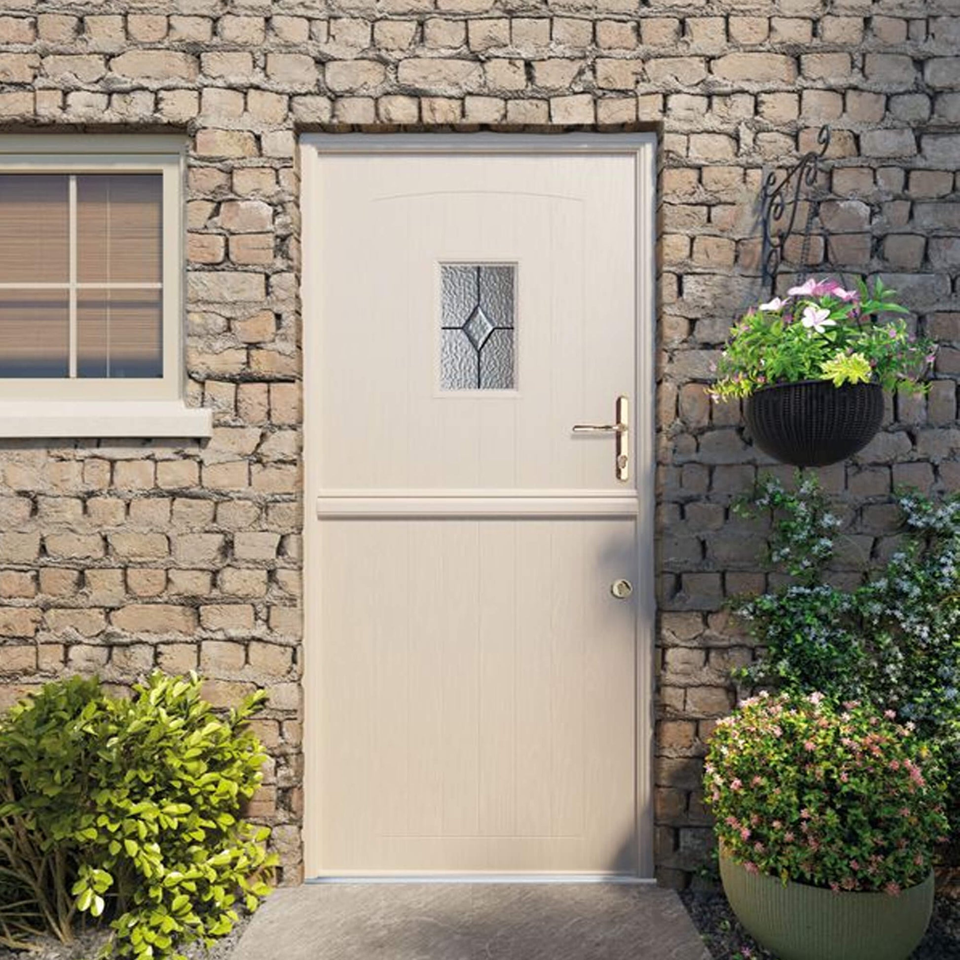 Beige Stable Composite GRP Door with decorative glass panel on a traditional farmhouse stone wall exterior.