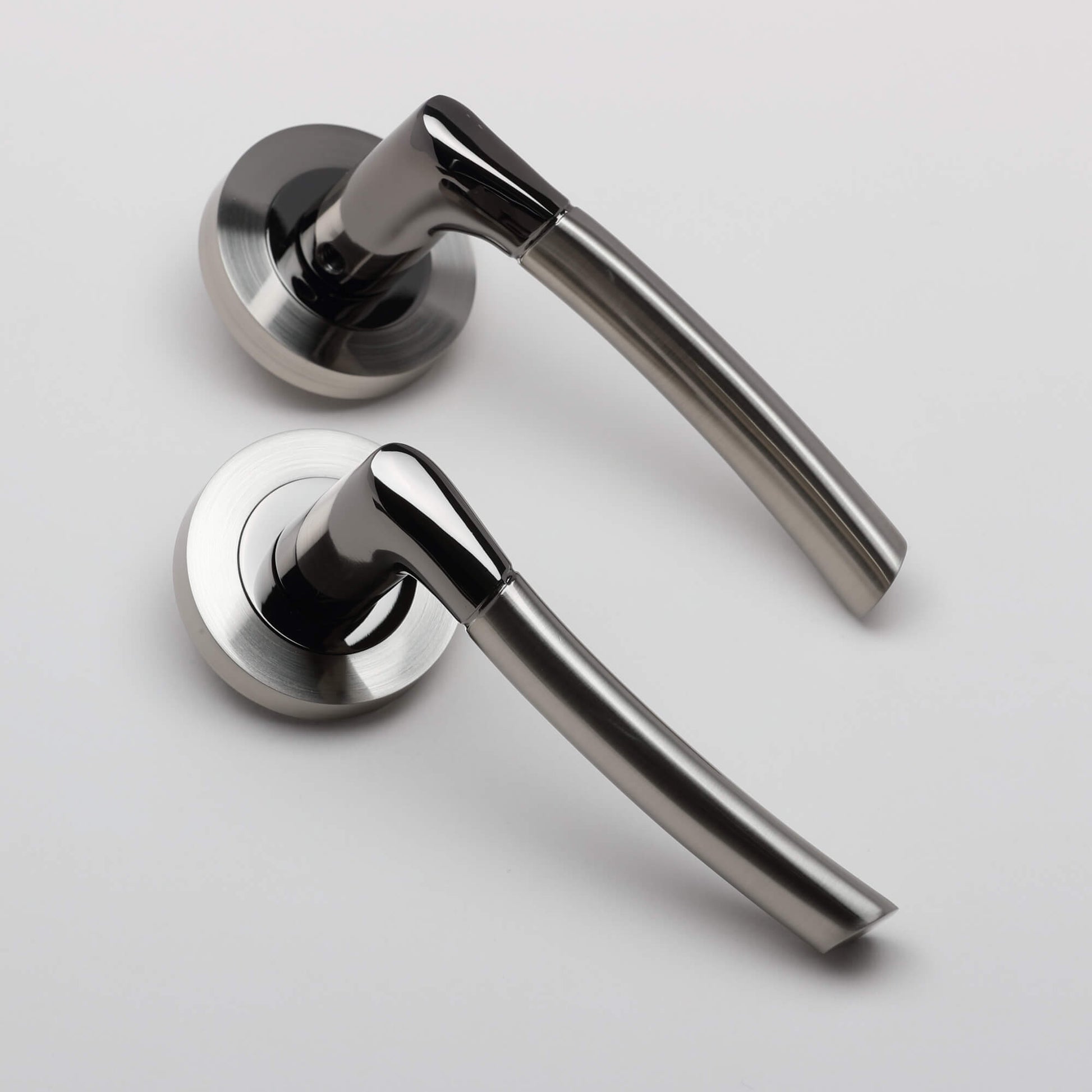 A pair of Storm Black Nickel & Nickel Brushed Handles on a white background