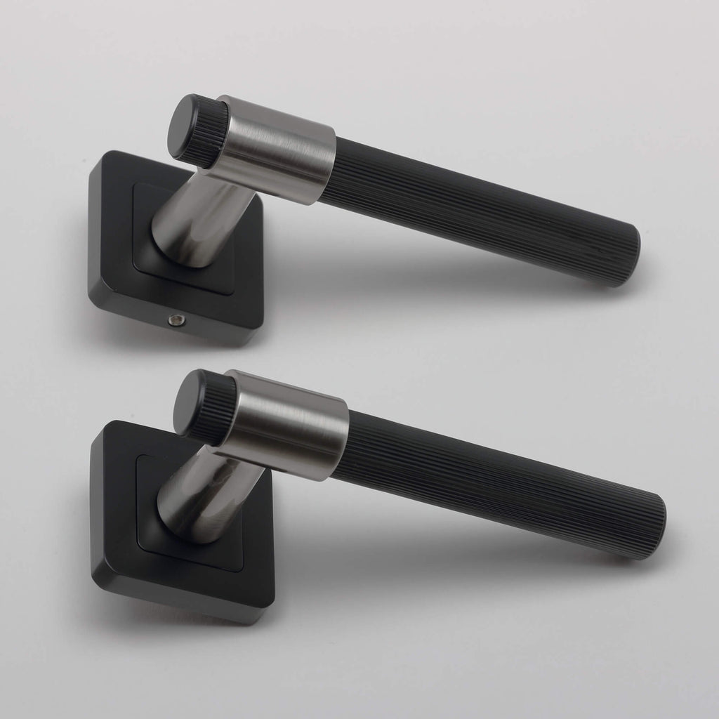 Side view of a pair of A Stratus Flat Black & Nickel Brushed Square Rose Handle on a light grey background.