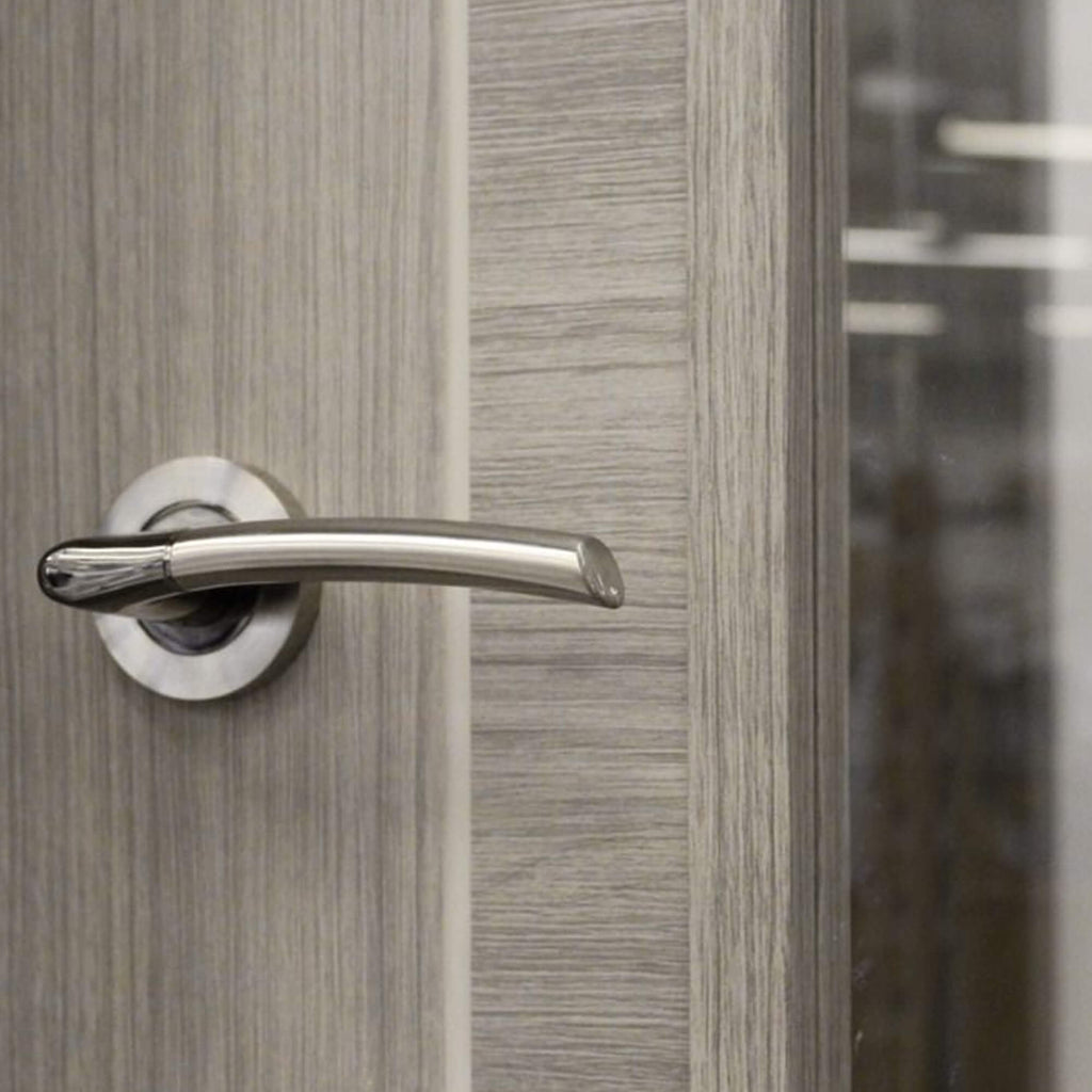 A close-up of the grooves and woodgrain on a Tigris Lava Grey 1 Lite Unglazed 40mm Internal Laminate Door, with a Storm handle and 4mm clear toughened glass.