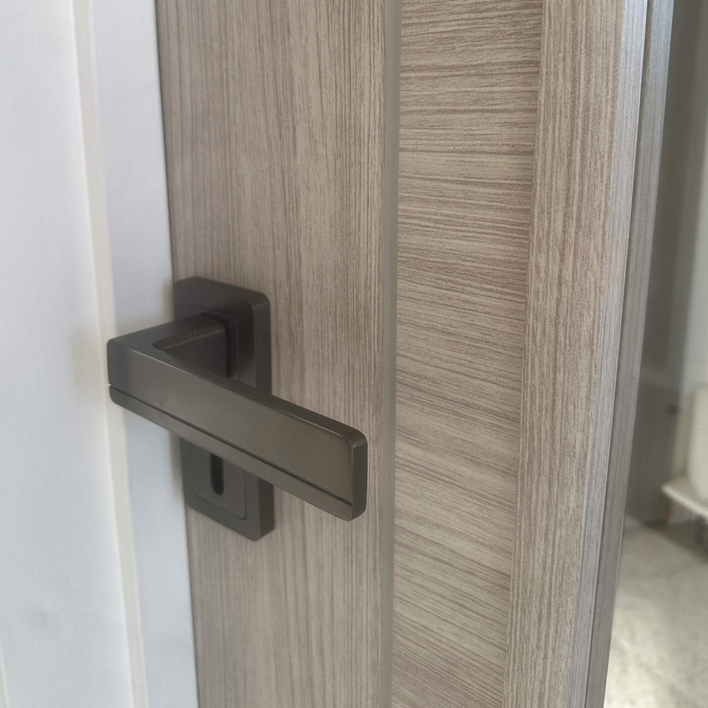 Close-up of the grooves and woodgrain on a Tigris Stone Grey 1 Lite Unglazed 40mm Internal Laminate Door, with 4mm clear toughened glass and an Alto handle.