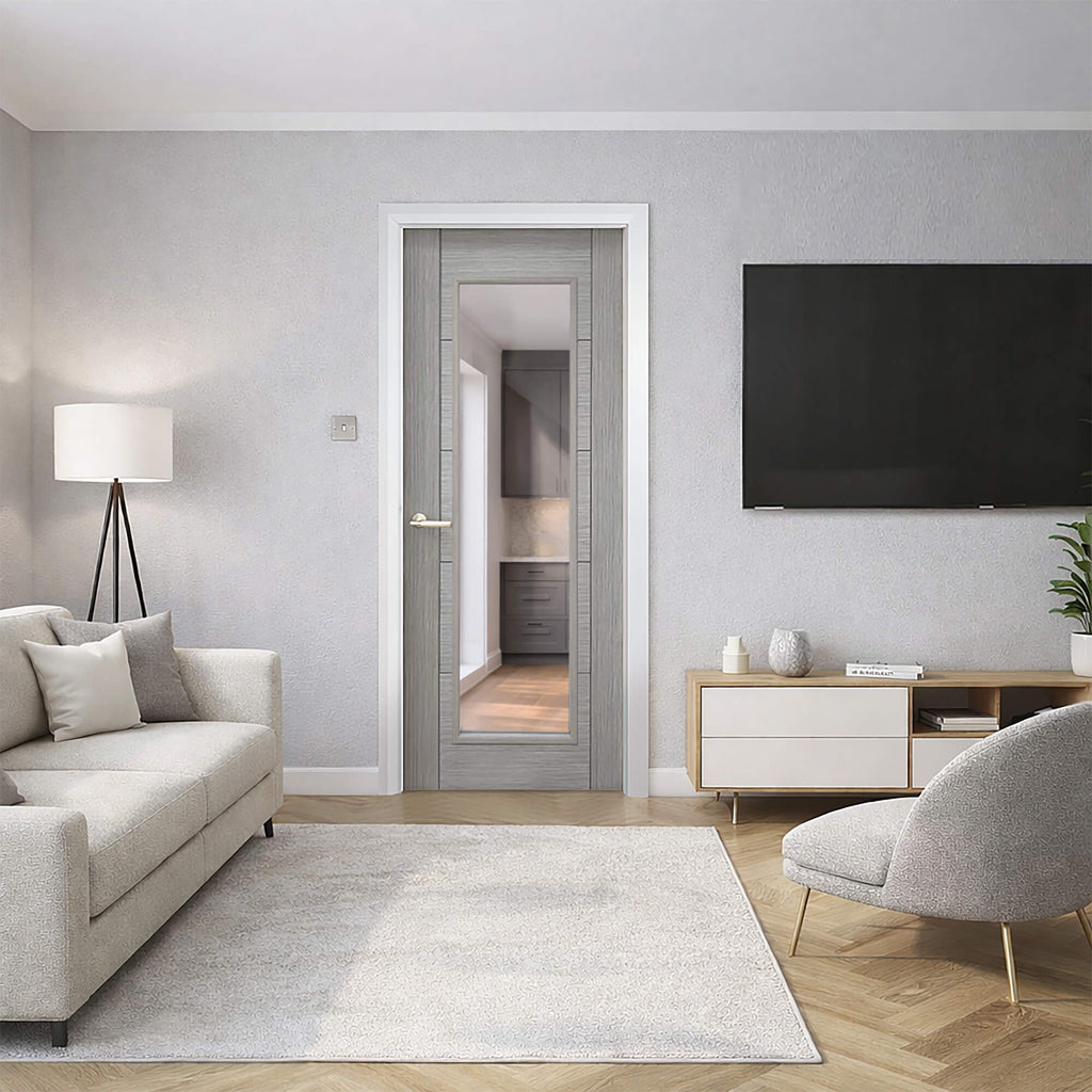 Modern living room with gray sofa, armchair, and TV on a light gray wall with a Tigris Urban Grey 1 Lite Pre‑Glazed Door.
