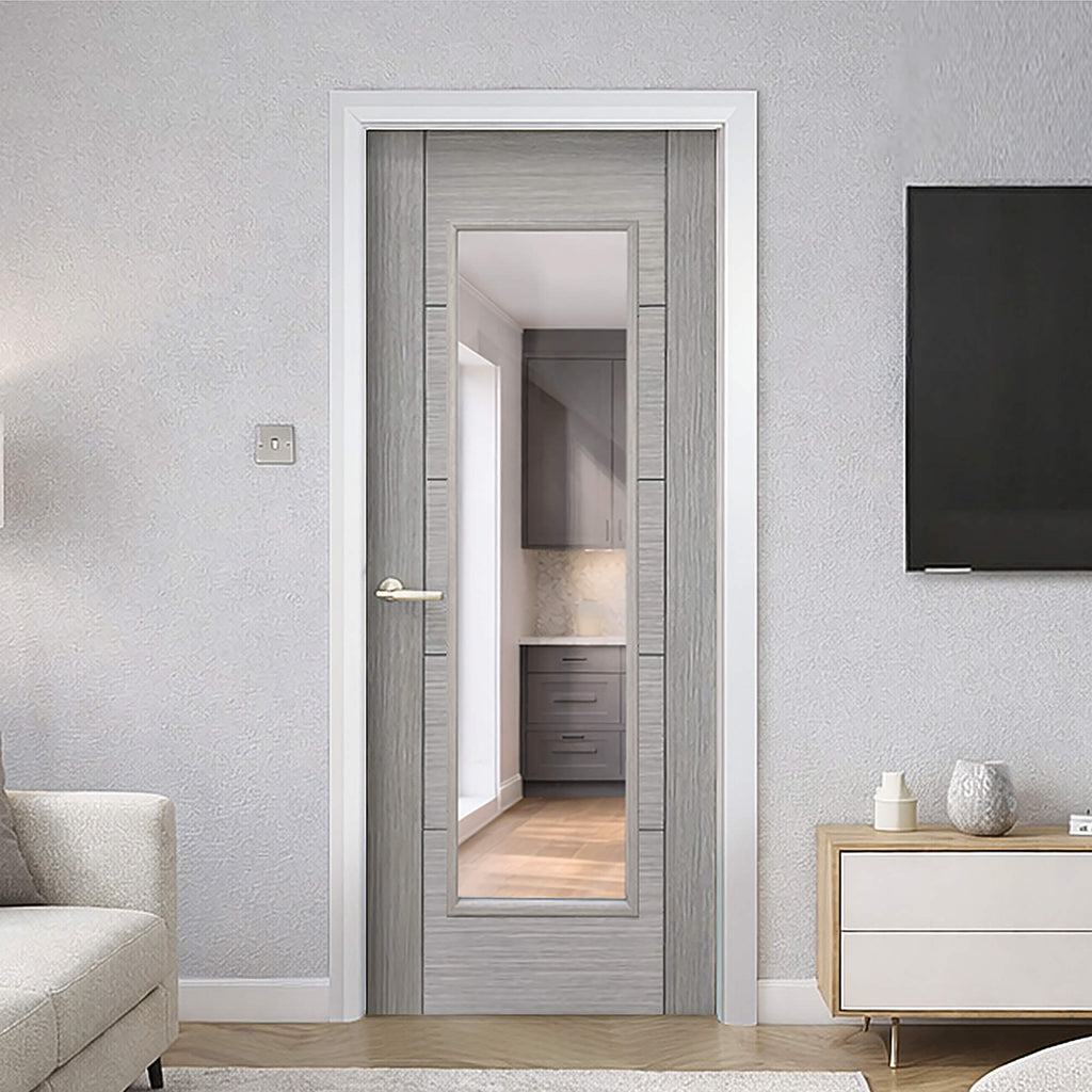 A Tigris Urban Grey 1 Lite Pre‑Glazed 35mm Internal Door, with a Knurled Satin Brass handle, in a modern home interior setting.