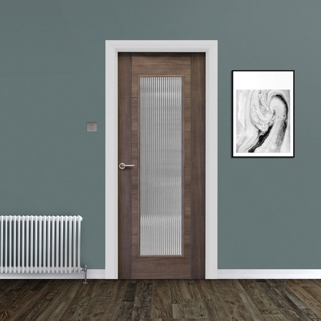 A Tigris Walnut 1 Lite Unglazed Laminate Door, with reeded glass inserted, with a Tempest handle in a home interior setting.
