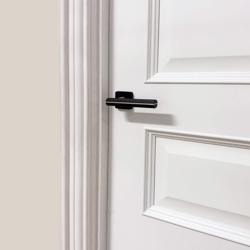 Close up of a Toledo White Primer Plus 3 Panel Door showing a Calvus handle.