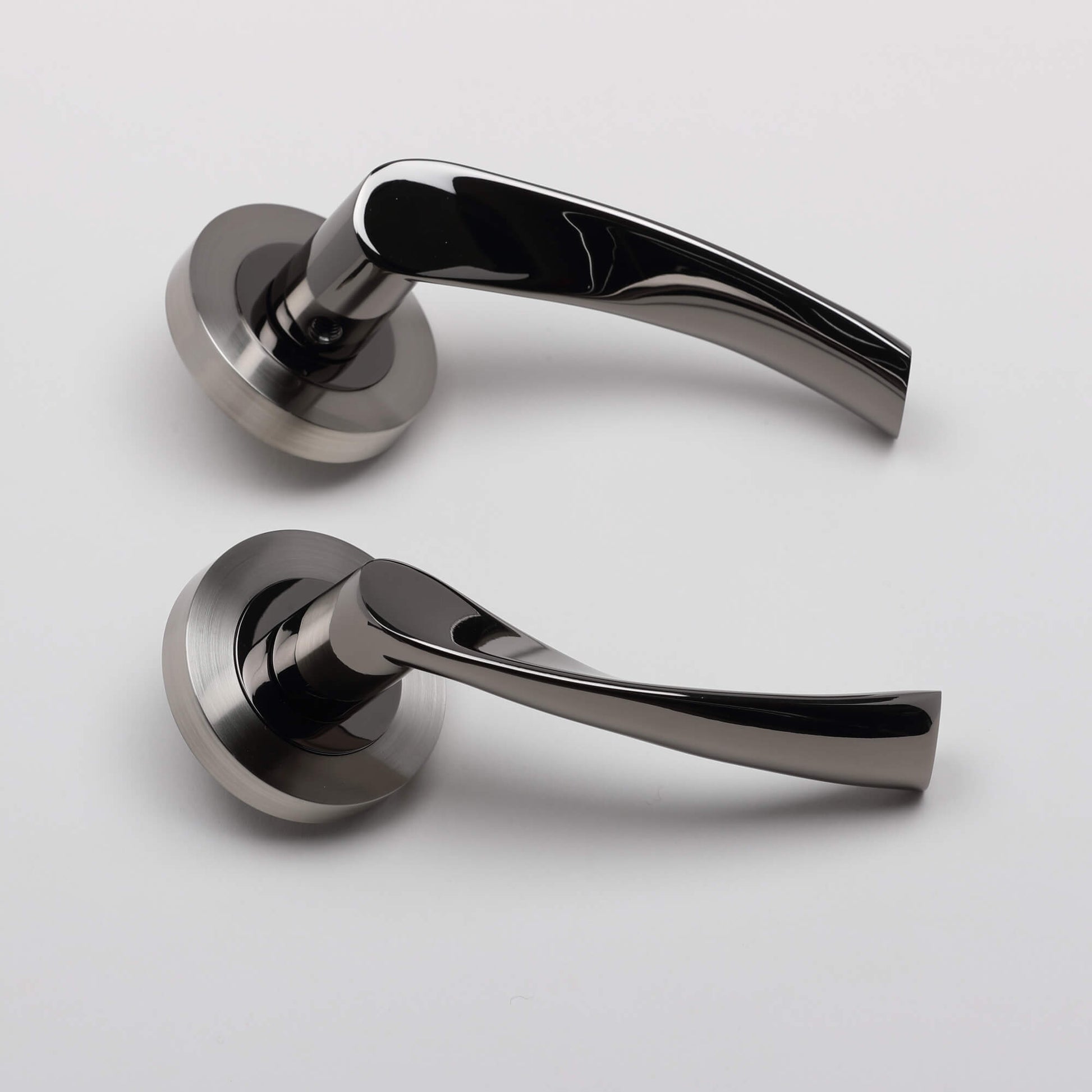 Side view of a pair of Trade Range Black Nickel & Nickel Brushed Door handles on a light grey background.