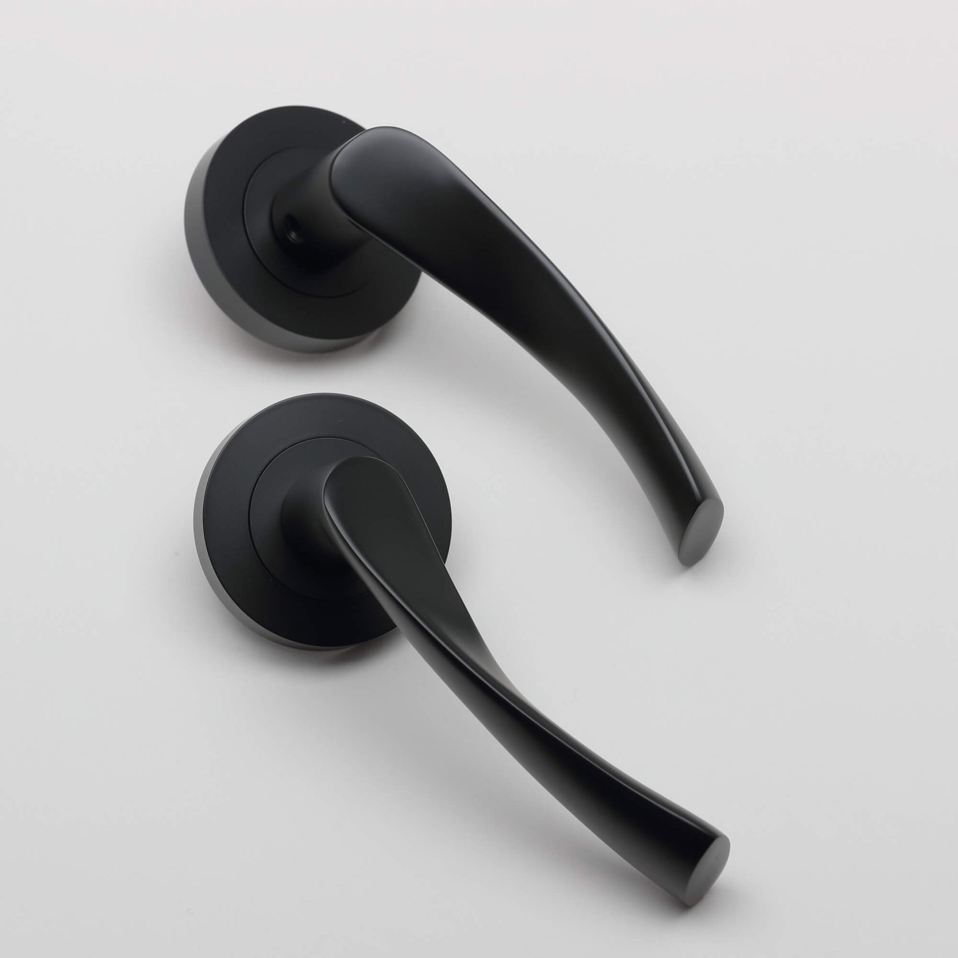 A pair of Trade Range Flat Black door handles on a white background.