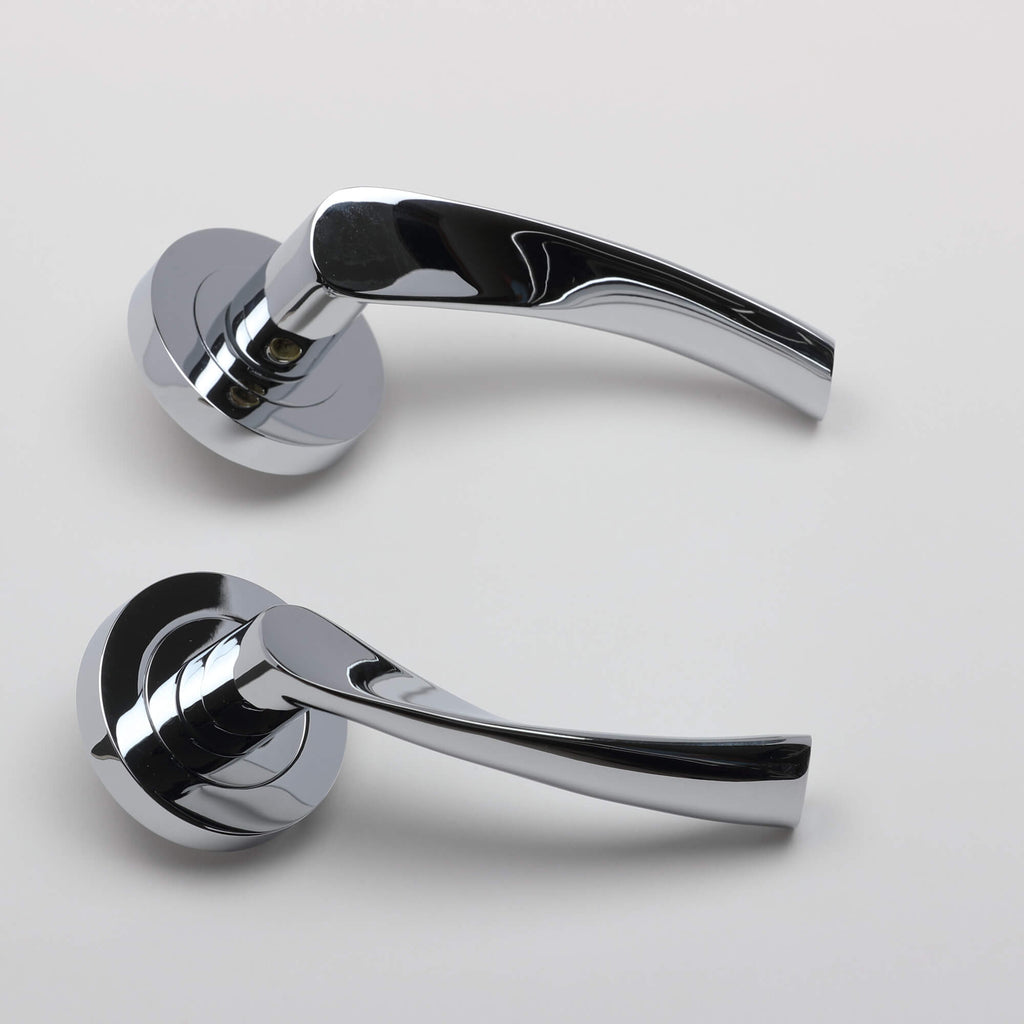 A side view of a pair of Trade Range Polished Chrome door handles on a grey background.