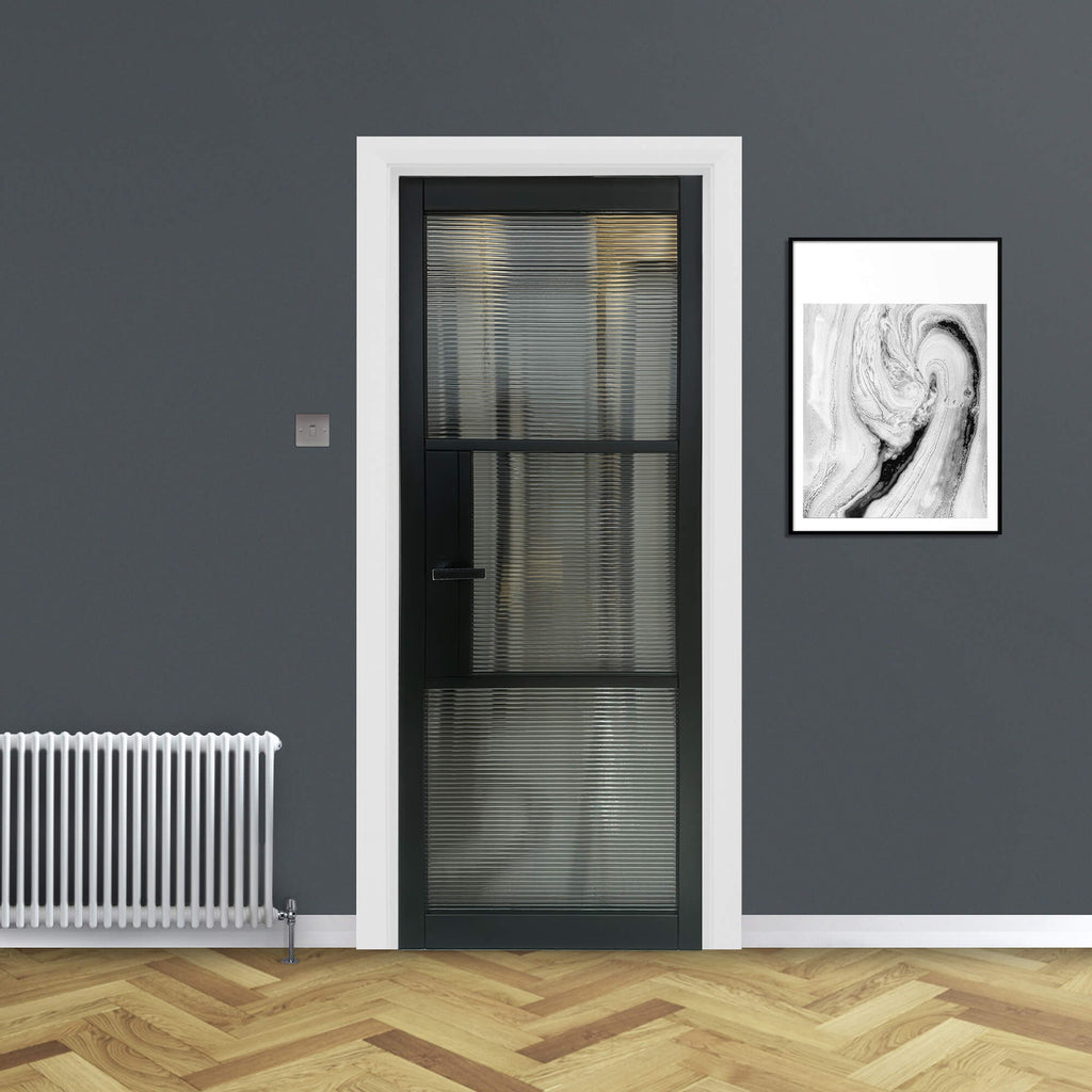 A Tribeca Black Primer Plus 3 Lite Reeded 40mm Internal Glass Door in an interior setting