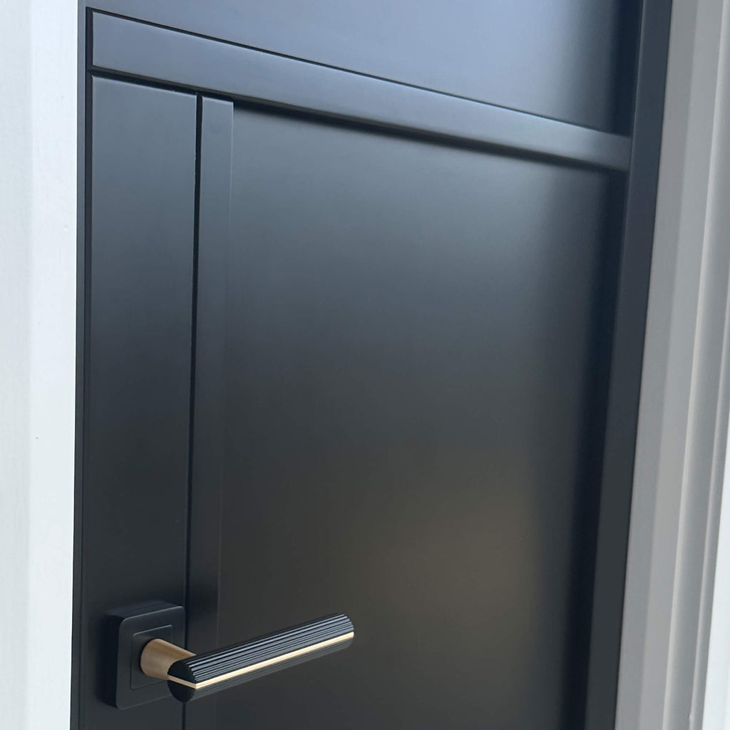 A close-up of a A Tribeca Black Primer Plus 3 Panel Internal 40mm Door with a Calvus handle.