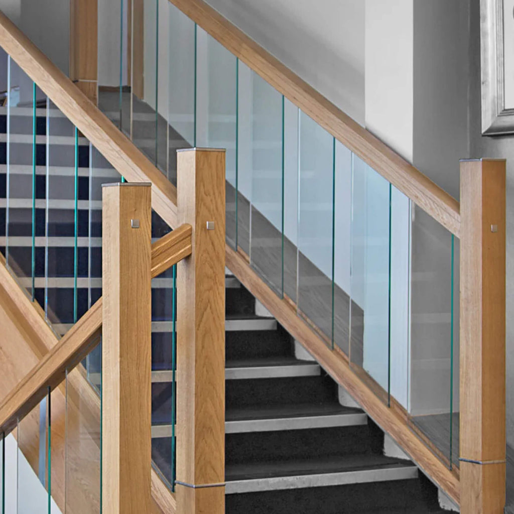 The Urban Staircase system displaying  wooden handrails and glass balustrades in a modern building.