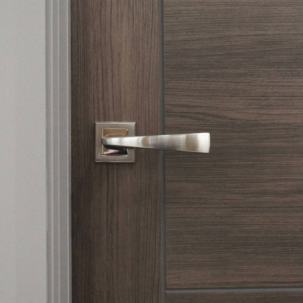Close-up of a Vancouver Walnut 40mm Laminate Door, with an Arcus handle.