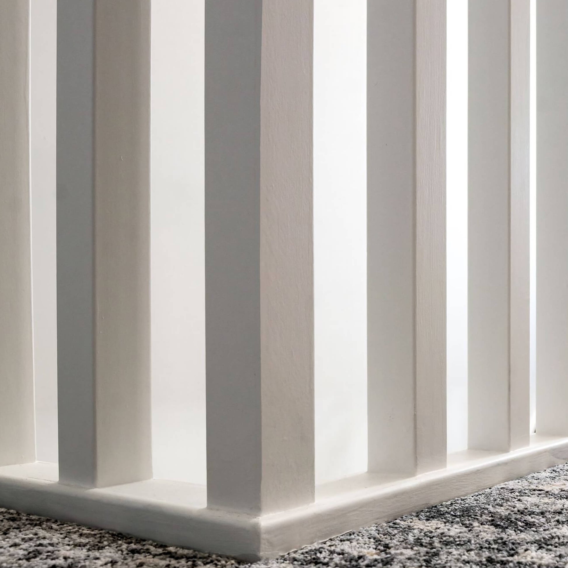 Close-up of White Primed Baserail (41mm Infill) on a carpeted landing floor 