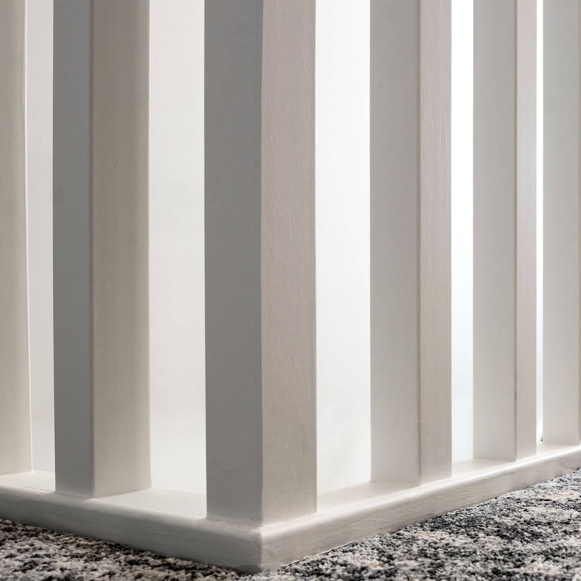 Close-up of white primed blank spindles on an upstairs landing