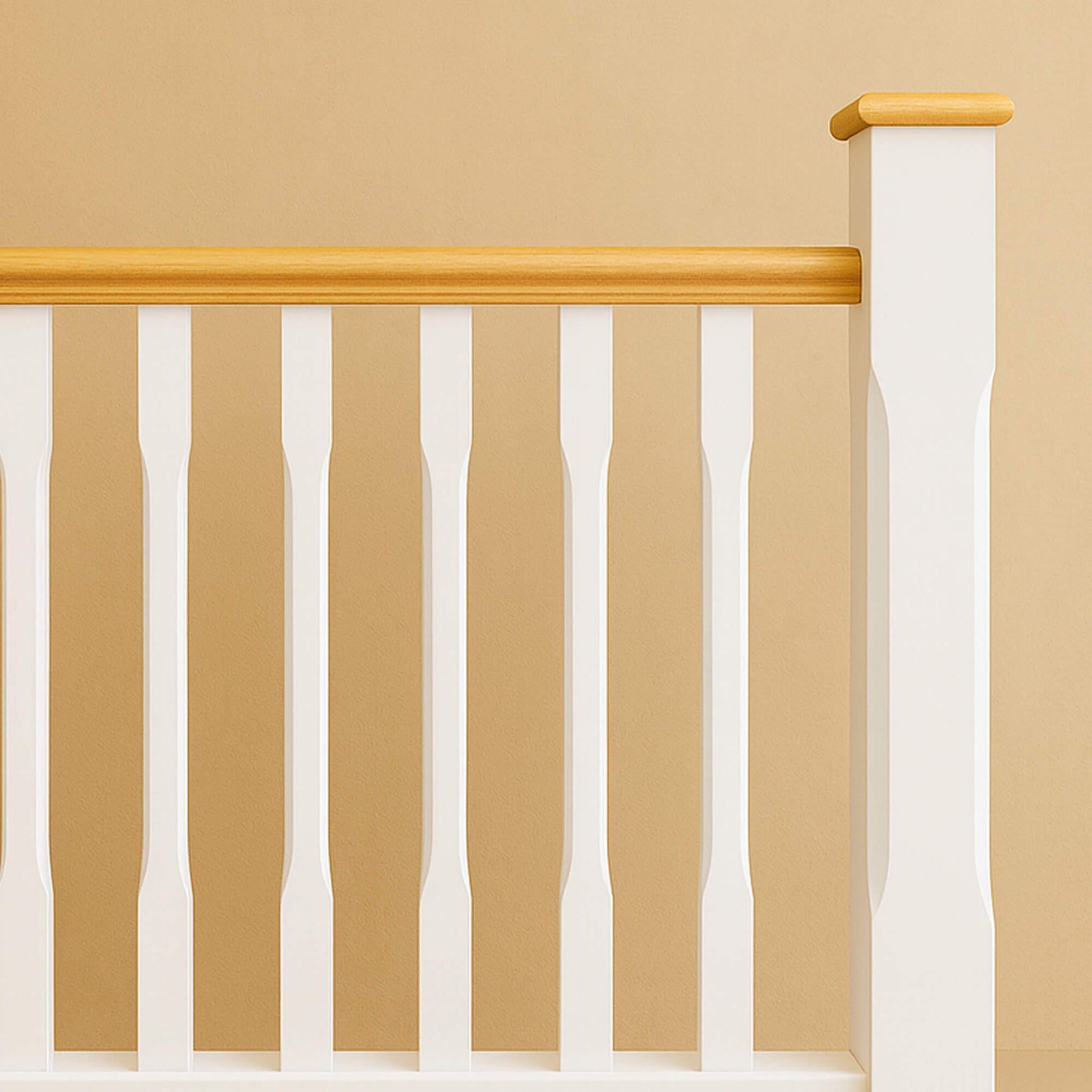 A White Primed Chamfered Newel Post with an oak pyramid newel cap, chamfered white spindles and oak handrail on a beige wall background.